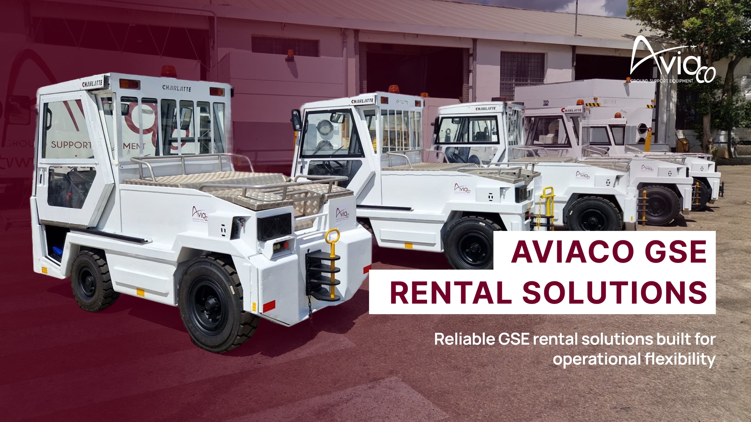 Line of white airport ground support vehicles, including belt loaders and passenger boarding stairs, parked on a sunny tarmac.