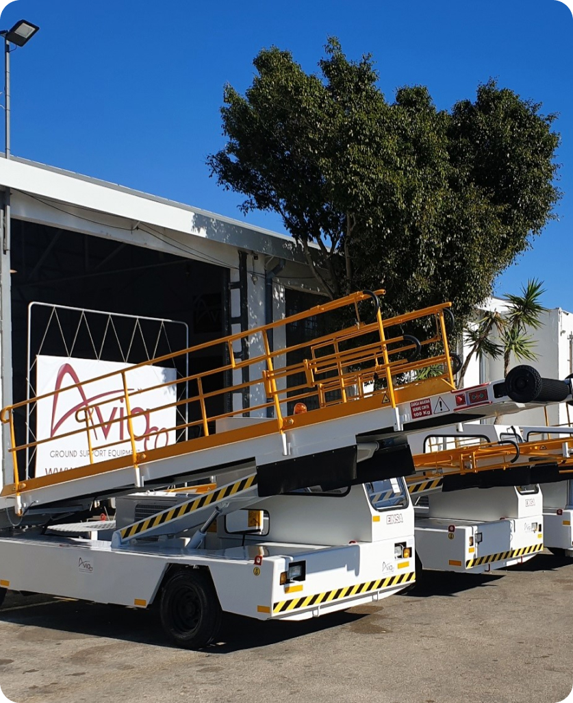 White Aviaco aircraft passenger stair trucks parked at GSE facility