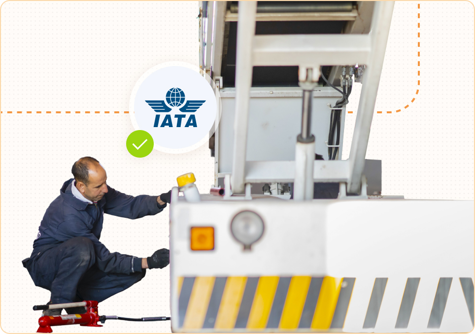 Technician maintaining white GSE with IATA certification badge